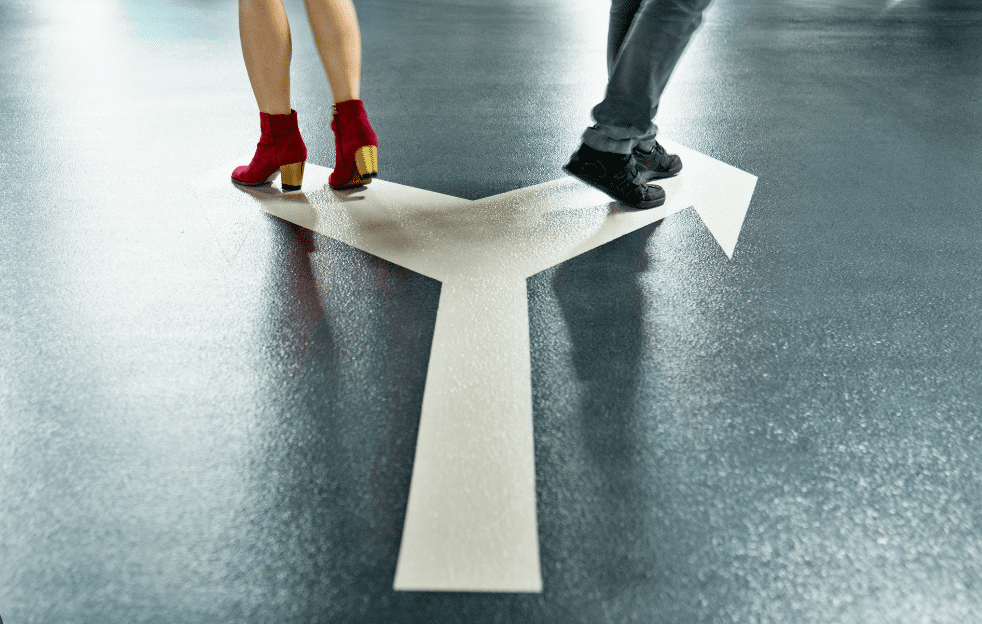Feet of two people on forked arrow