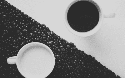 Two coffee cups on diagonal coffee beans