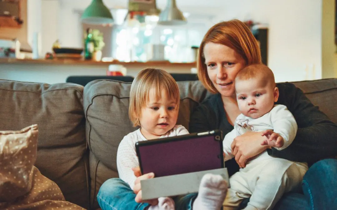 Mother and two children watching tablet