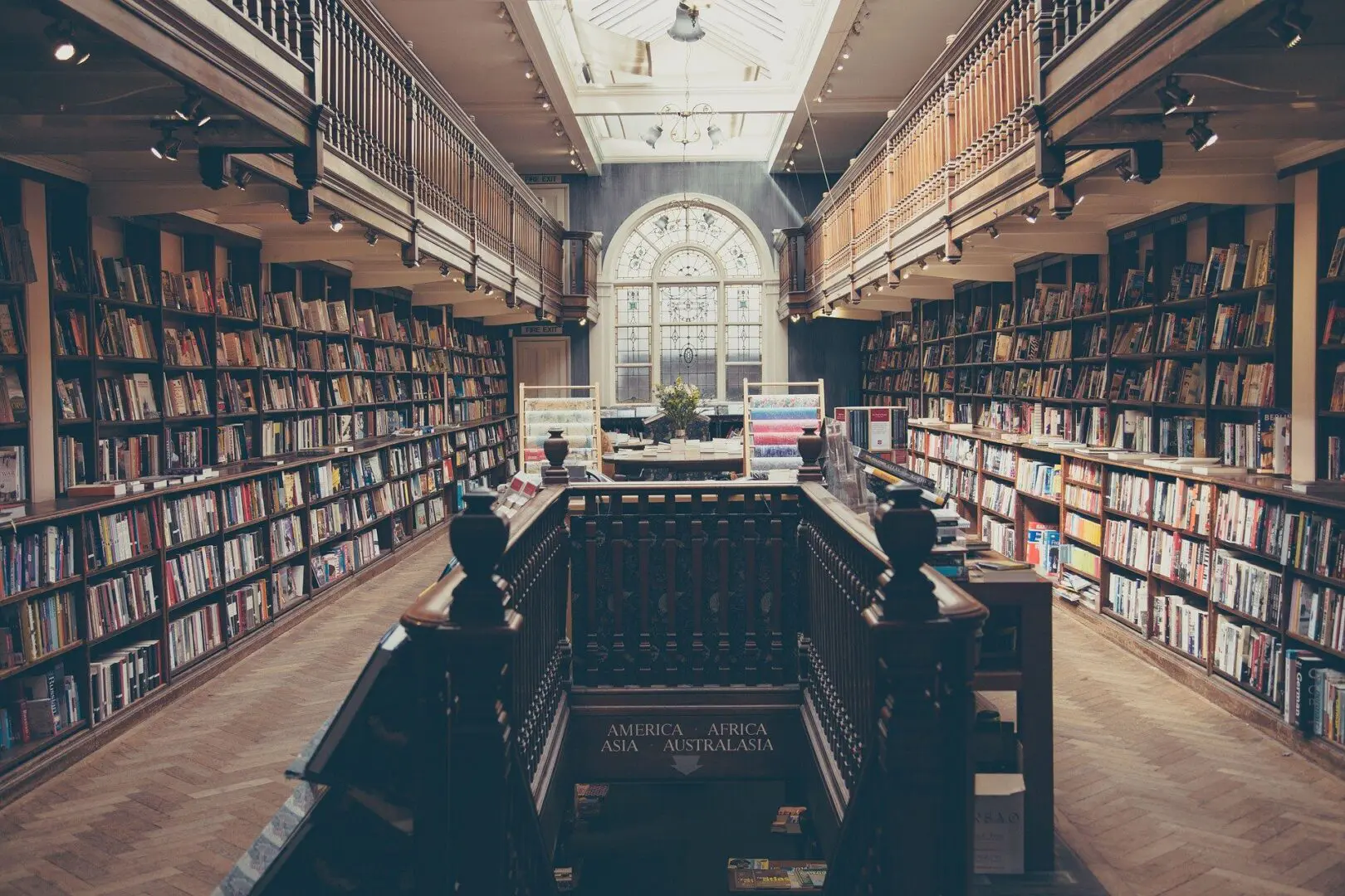 Elegant library with wooden balconies and bookshelves