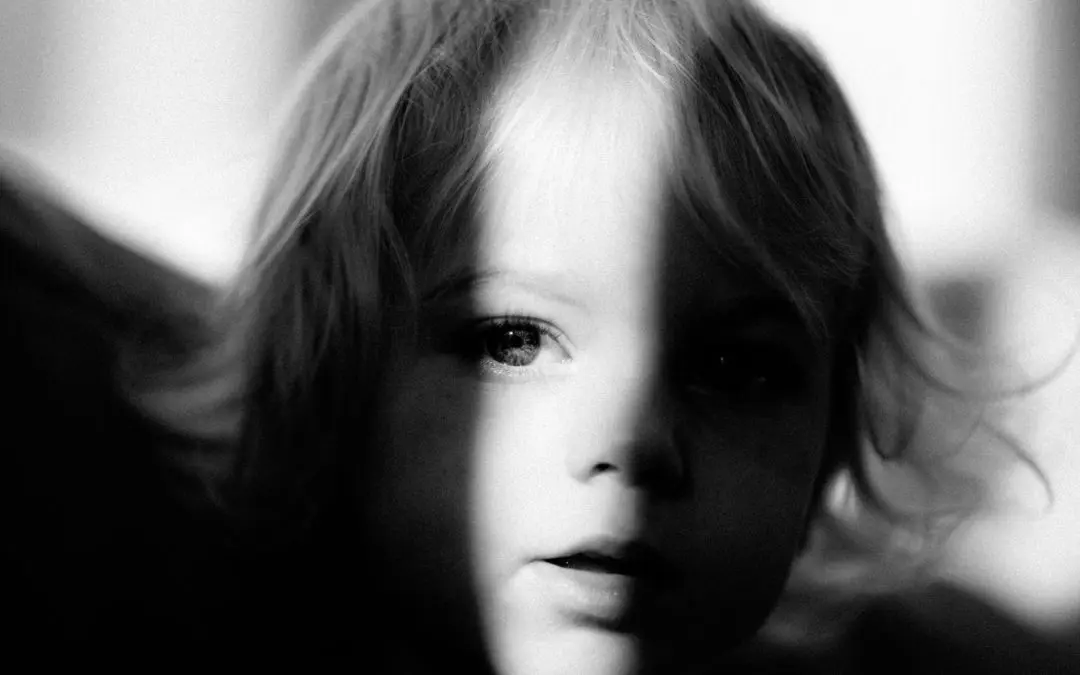 Black-and-white portrait of child with shadow