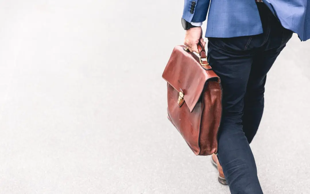 Person walking with brown leather briefcase