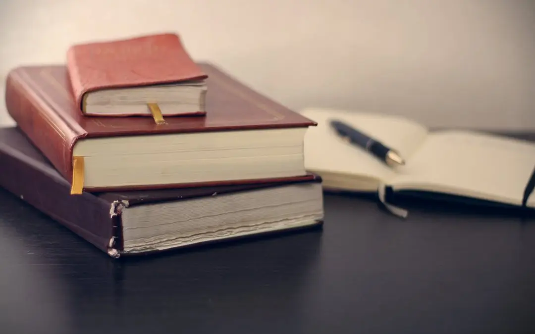 Stack of leather notebooks with open journal
