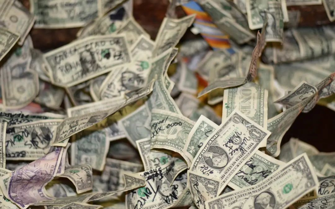 Scattered signed one-dollar bills