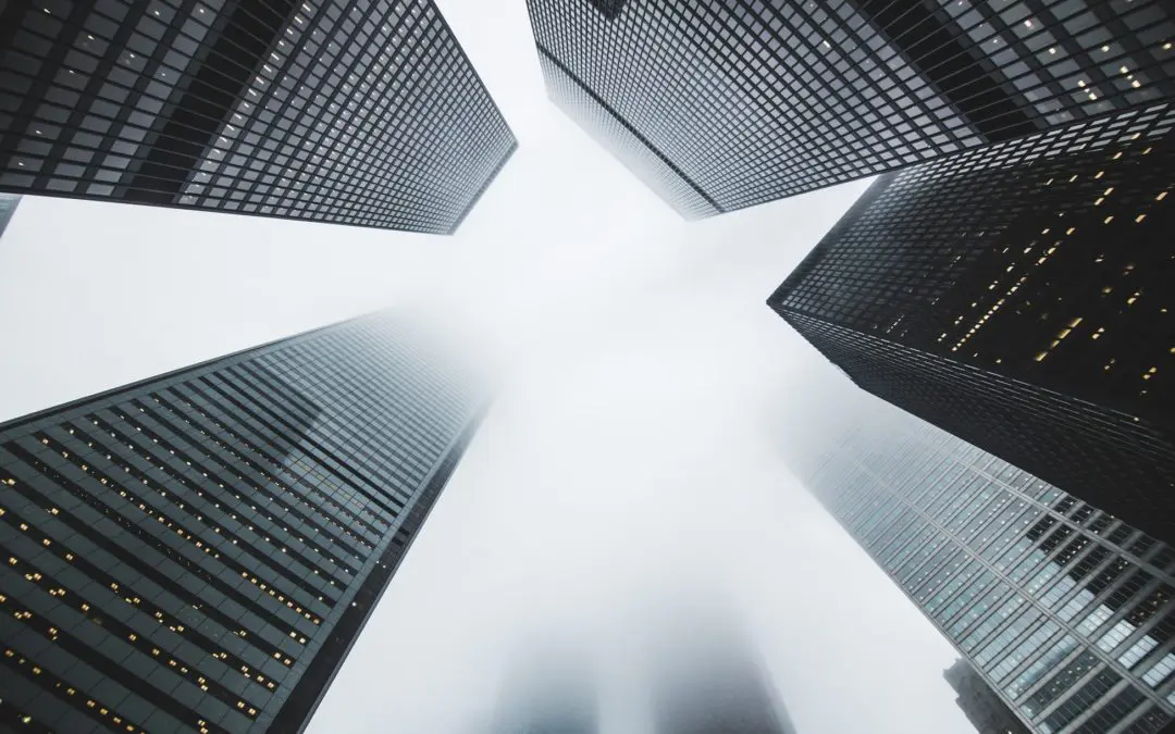 Fog-shrouded skyscrapers viewed from below