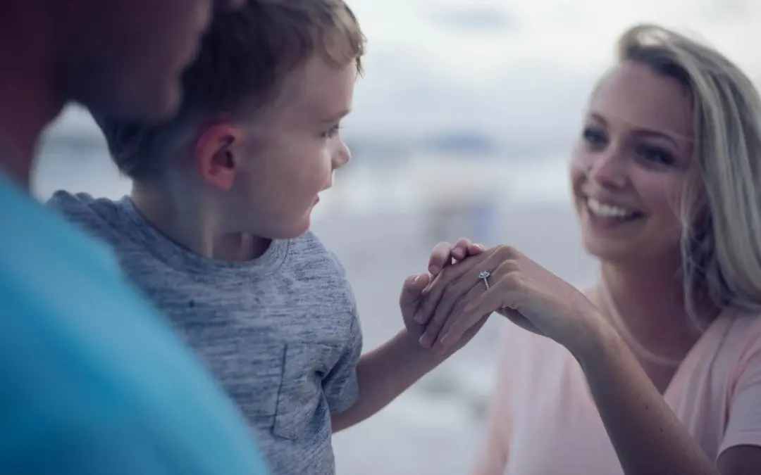Smiling woman showing ring to young boy