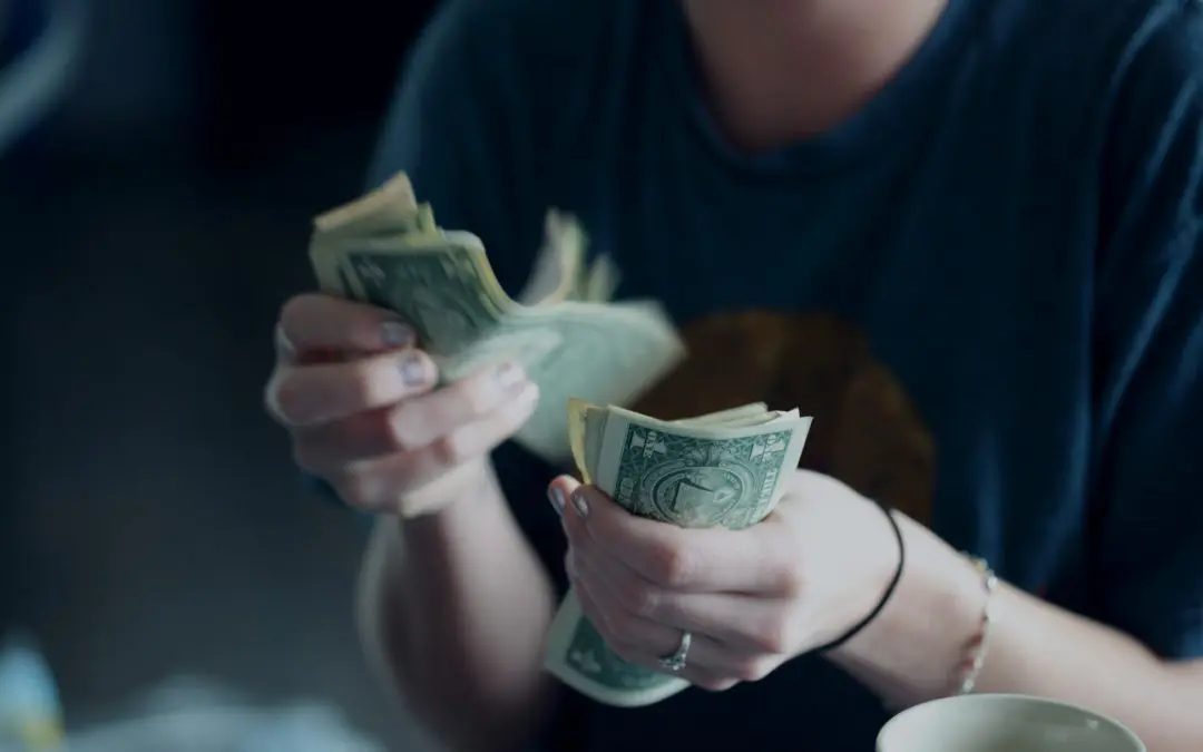 Hands counting US dollar bills