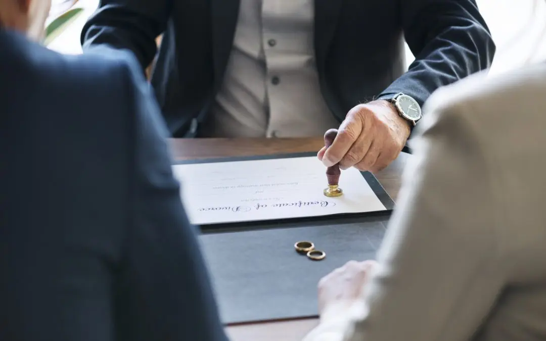 Official stamping wedding certificate with rings on table