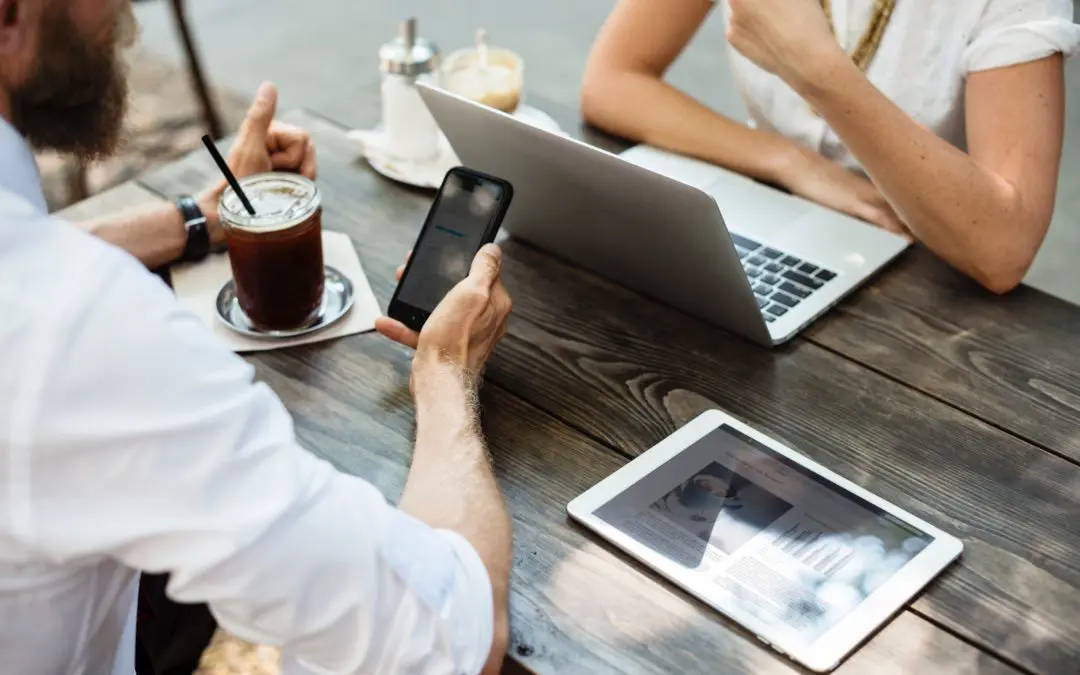 Business meeting at cafe with laptop and tablet