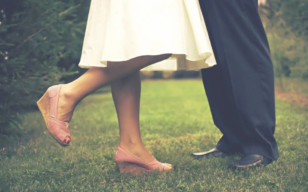 Couple's legs; woman on tiptoe in wedges
