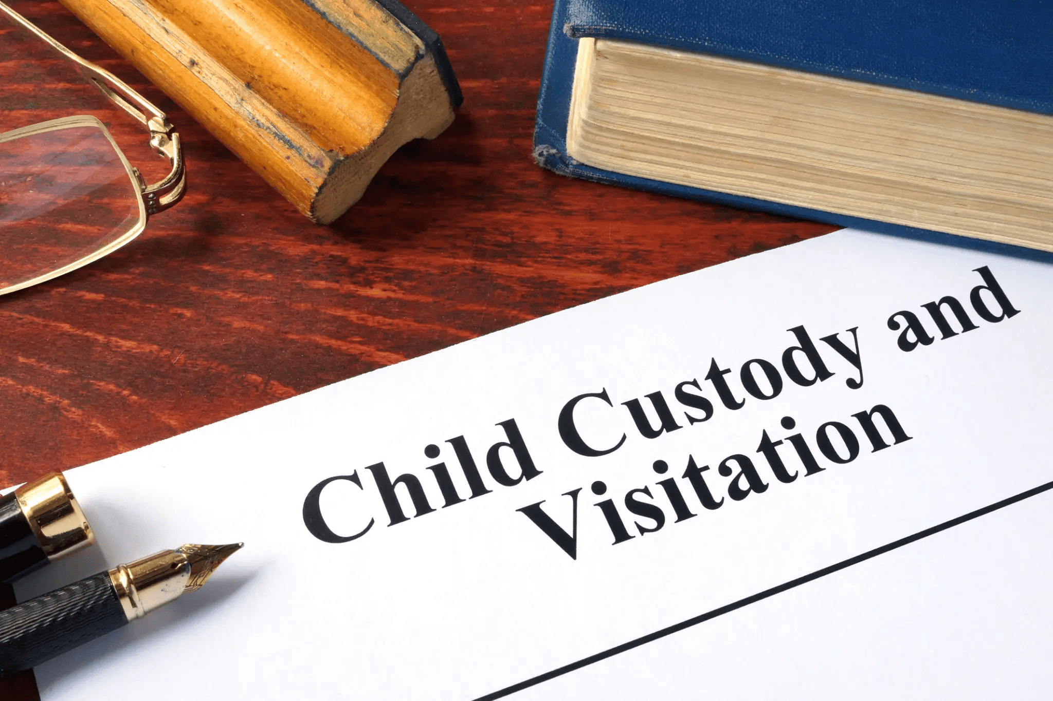 Child custody document with pen and book.
