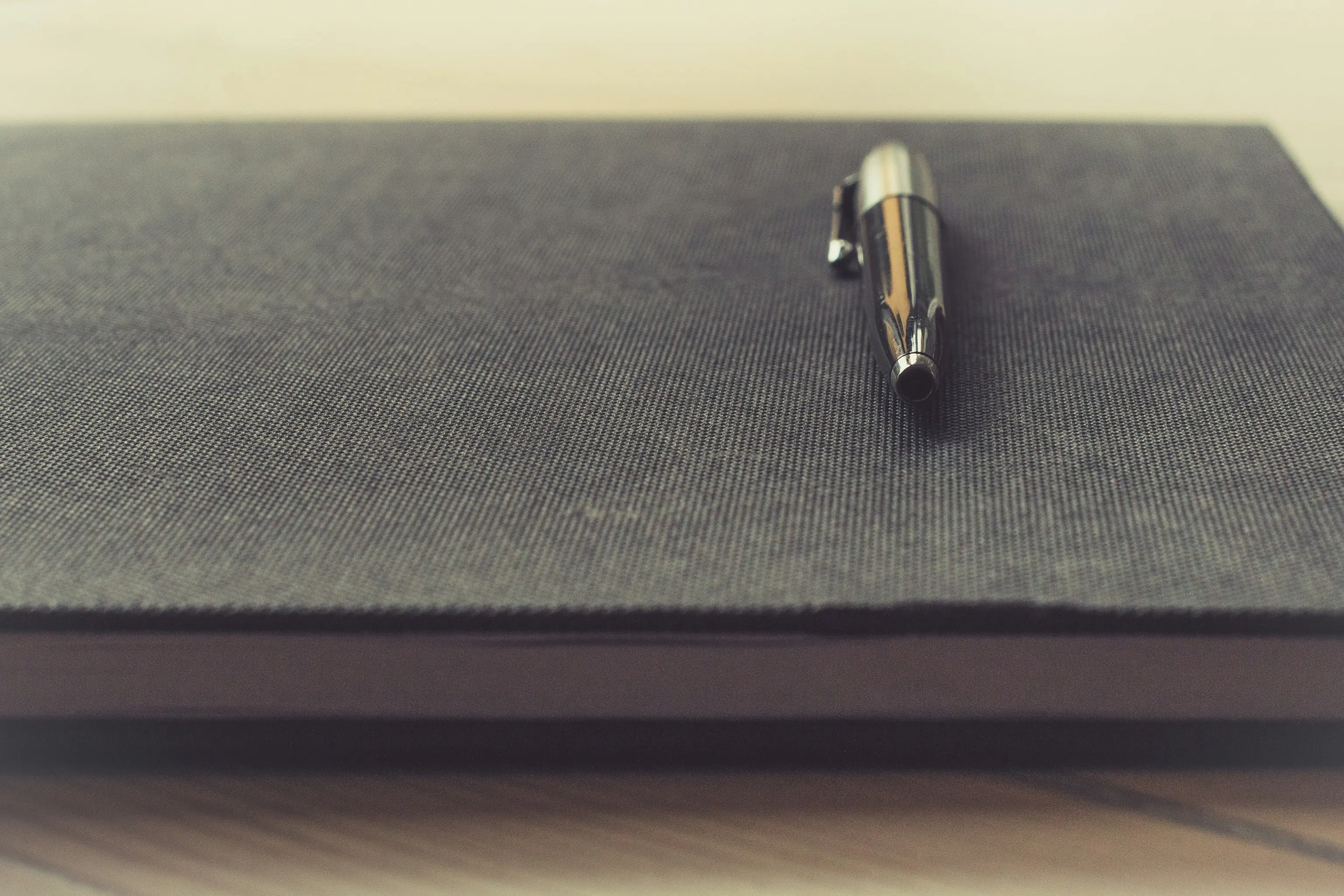 Silver pen on closed textured notebook